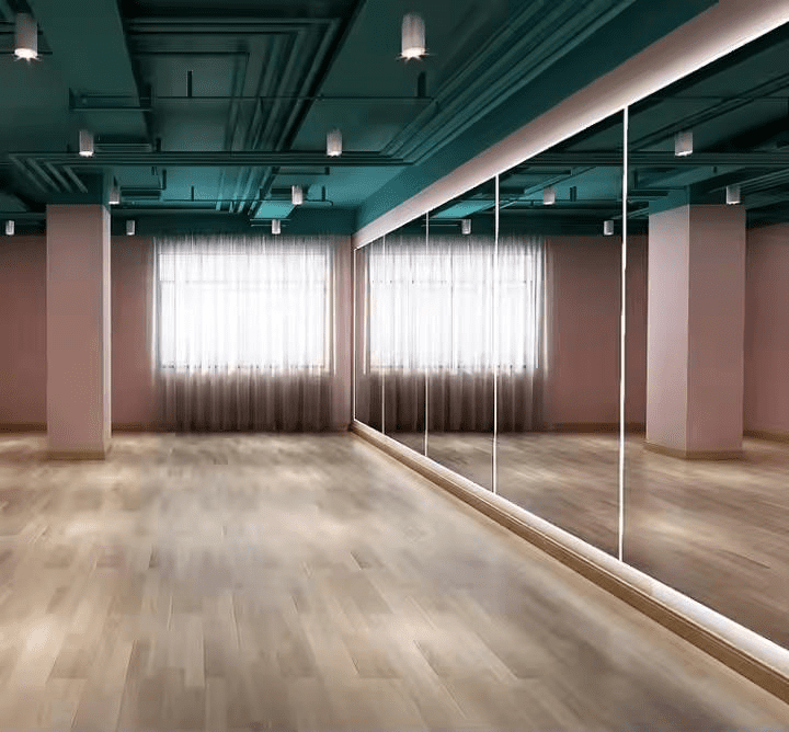 Custom wall mirror in a studio with wood floor